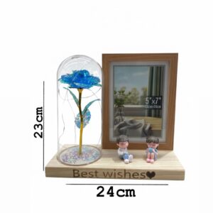 Artificial rose in a glass dome with a photo frame and LED lights.