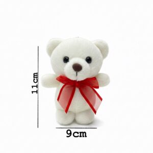 White  teddy bear keychain holding a ribbon