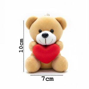 Light-brown teddy bear keychain holding a red heart