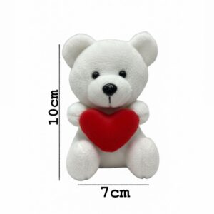 White  teddy bear keychain holding a red heart