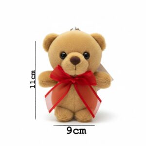 Light-brown teddy bear keychain holding a ribbon