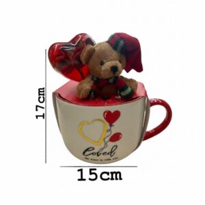 a ceramic mug and a small teddy bear